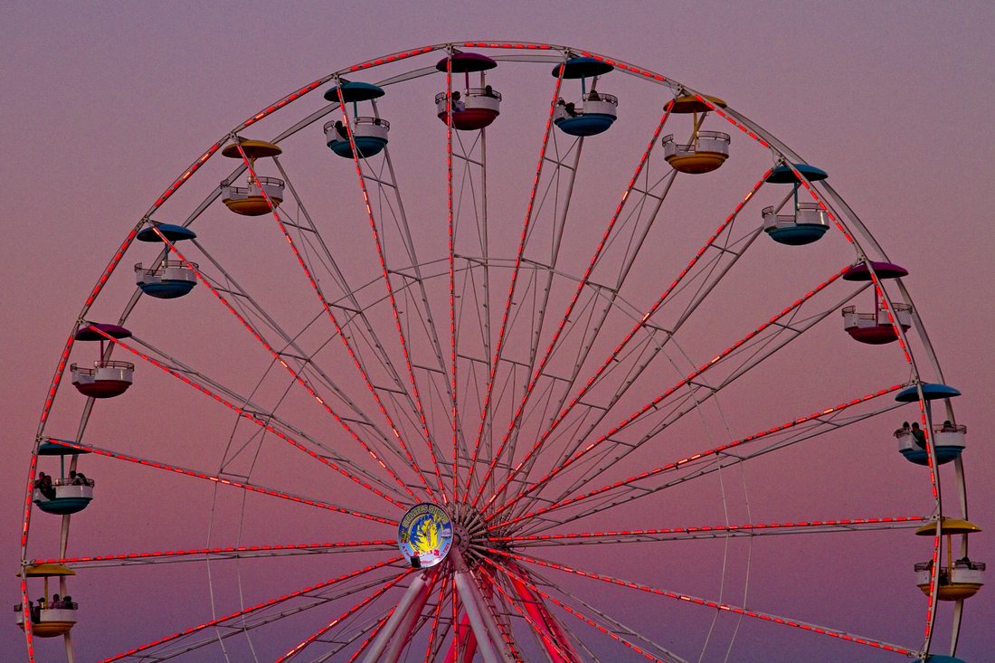 Carnival ferris wheel silhouetted against a gradient purple twilight sky — Carolina Classic Fair, Winston-Salem NC