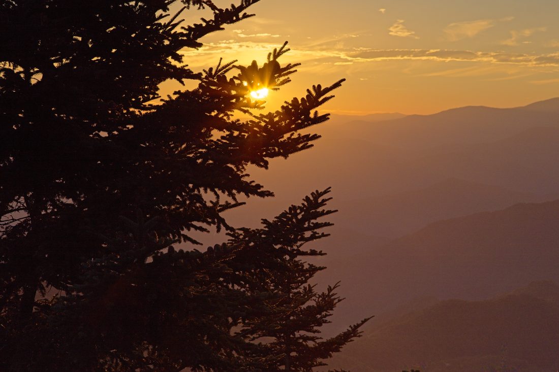 Soft sunset light spreading across distant Blue Ridge ridgelines — Blue Ridge Parkway