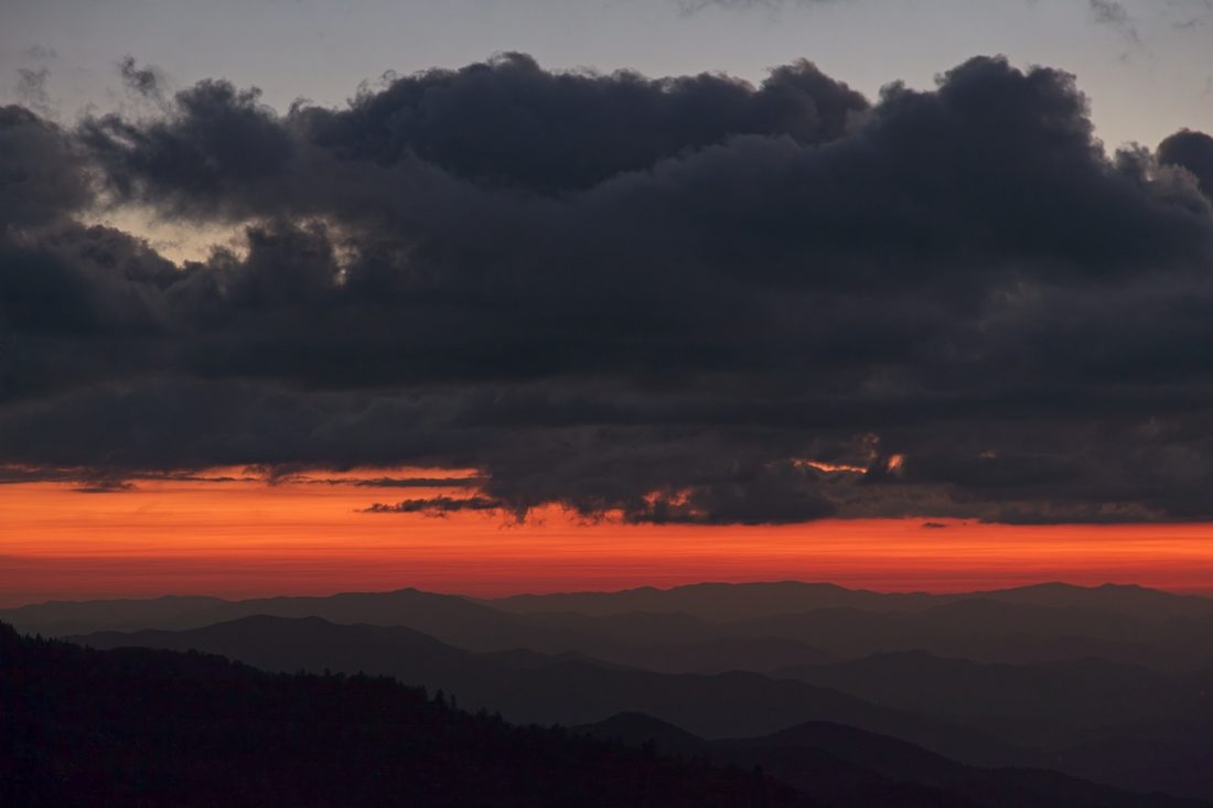 Molten red horizon under dramatic cloud bands at sunset over the Blue Ridge — Blue Ridge Parkway